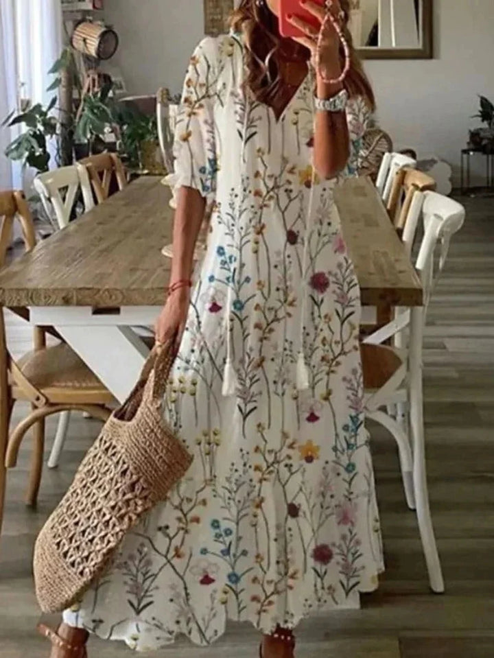 "Emily - Elbow sleeve floral maxi dress in multiple colors, featuring a soft and flowy fabric with a colorful floral print…