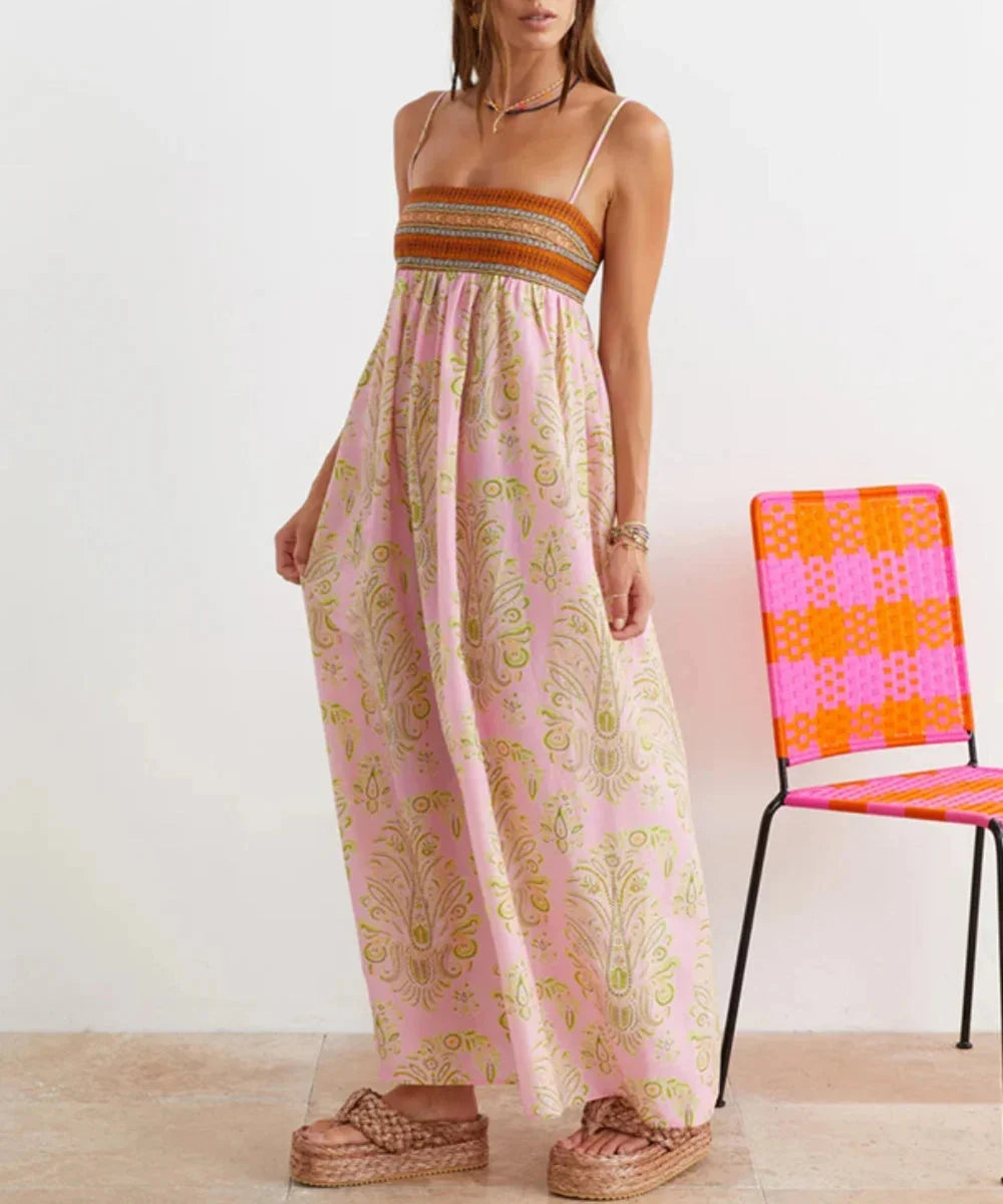 Pink strapless maxi dress with bohemian design. Features delicate fabric with flowy silhouette and intricate detailing.