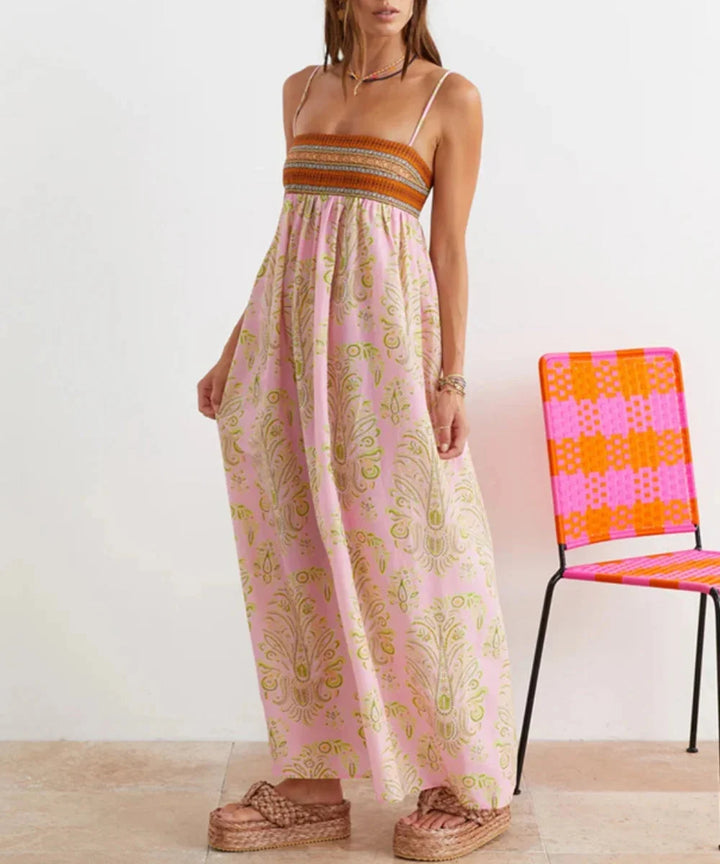 Pink strapless maxi dress with bohemian design. Features delicate fabric with flowy silhouette and intricate detailing.