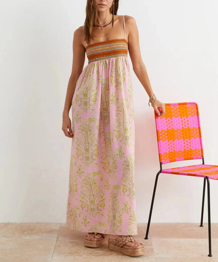 Light pink strapless maxi dress with bohemian flair, featuring intricate lace details and a flowy silhouette.