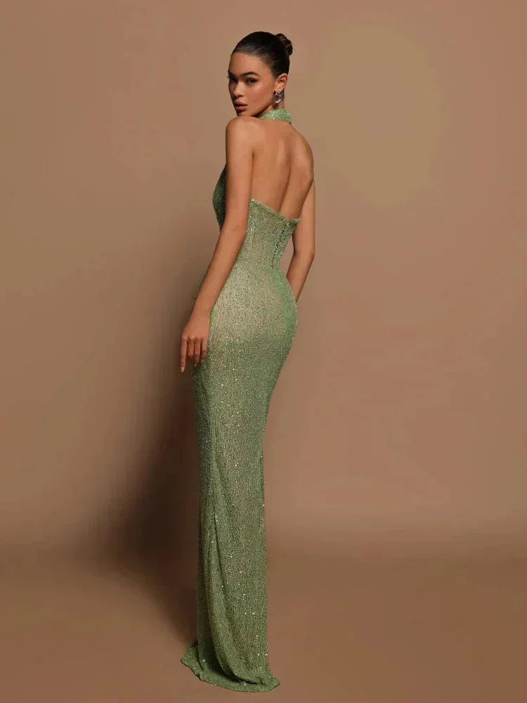 Green halterneck evening dress with shimmering fabric, perfect for special occasions.