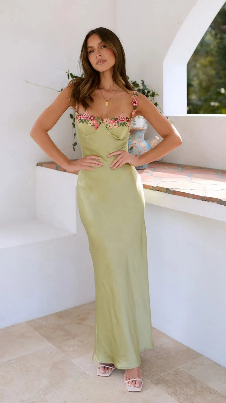 "Sage maxi dress featuring delicate embroidered pink florals on a flowy design"