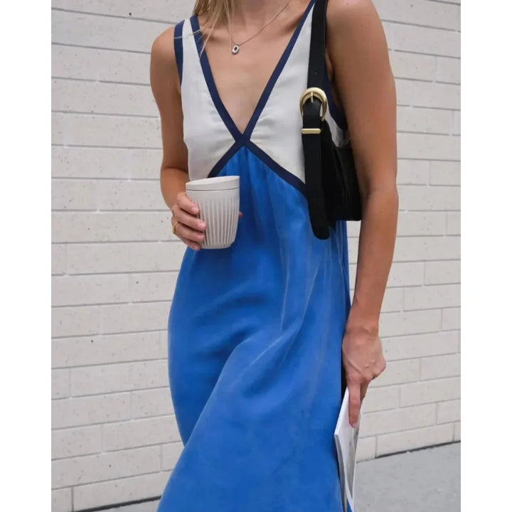 Blue satin maxi dress with a sleek silhouette and V-neck. Ideal for evening occasions and special events.