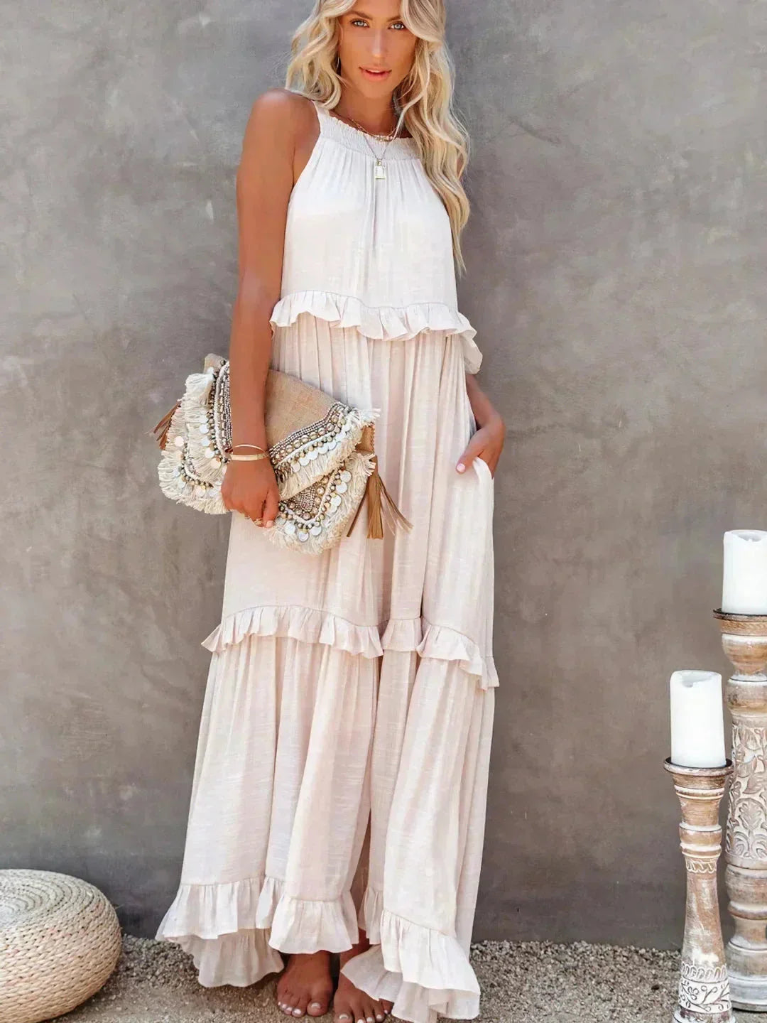 Apricot tiered maxi dress in lightweight fabric with a sleeveless design, perfect for warm weather.