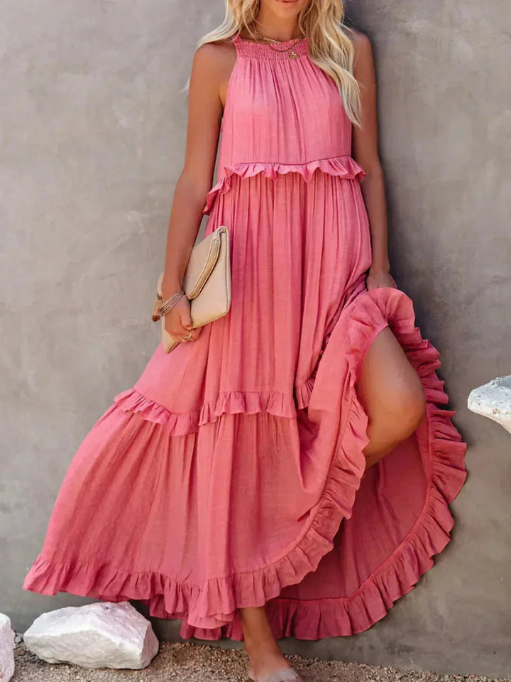 Pink sleeveless tiered maxi dress by Greyson, featuring a flowy design and a lightweight fabric perfect for any summer…