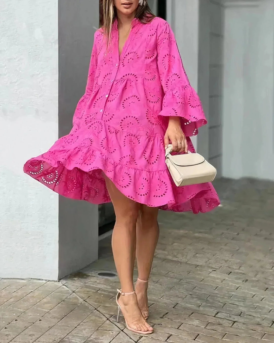 Dark pink ruffled broderie anglaise mini dress, featuring intricate embroidery details and a feminine design.