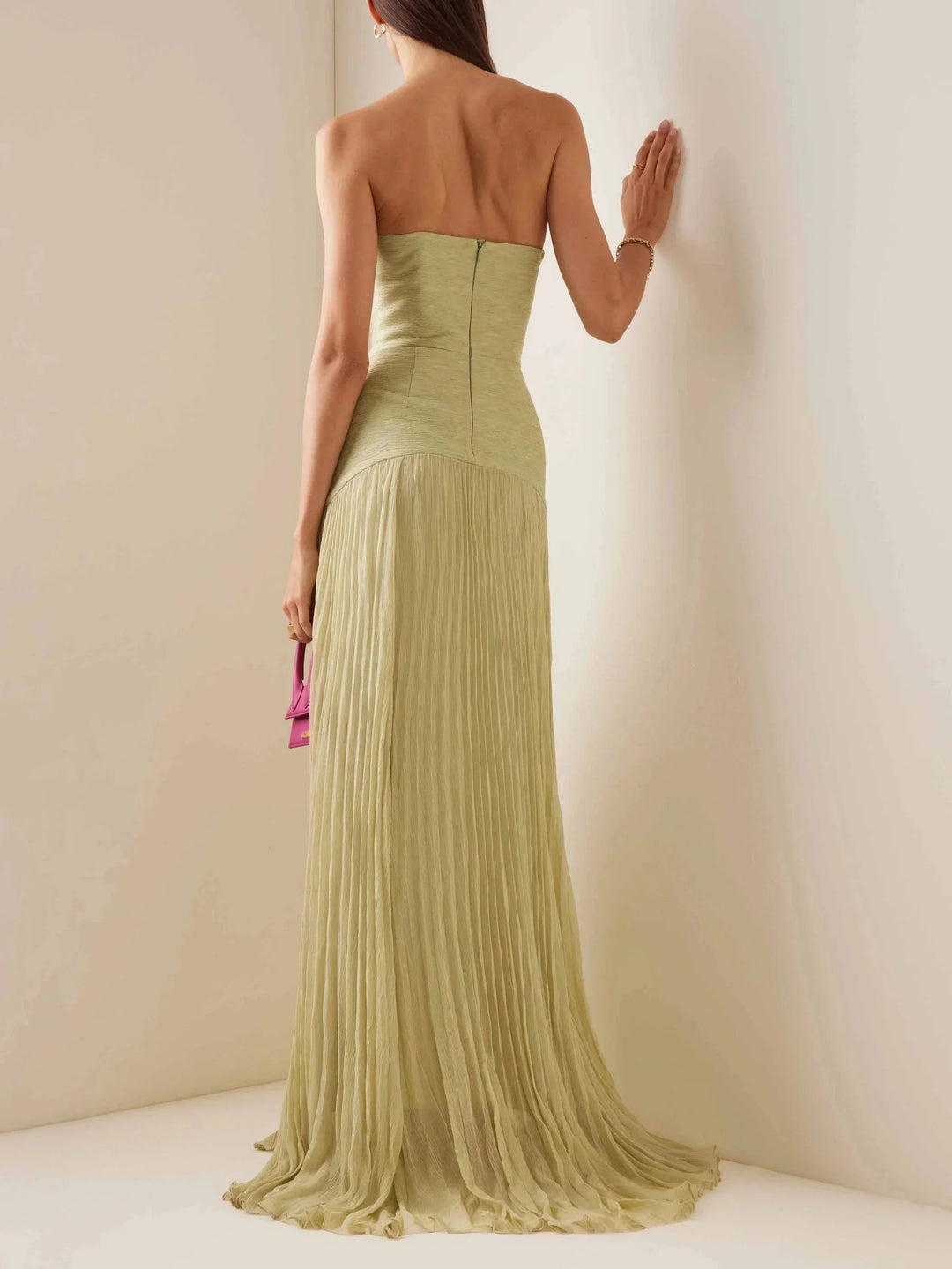 Light green strapless maxi dress with pleated design. Perfect for evening events or special occasions.