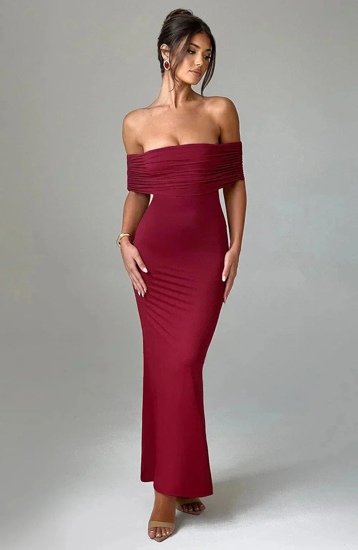 Red off-shoulder ruched dress, with a fitted design. Made of stretchy fabric with a unique ruched detailing on the side.