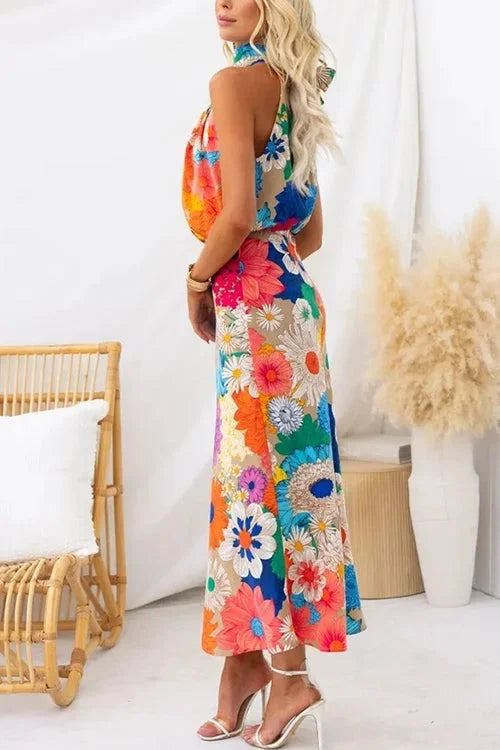 "Multicolored floral halter maxi dress with vibrant design, perfect for summer. Made from lightweight and breathable fabric."