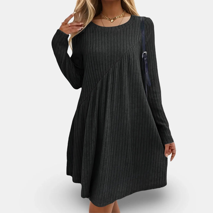 Black mini dress with long sleeves, featuring textured swing design.