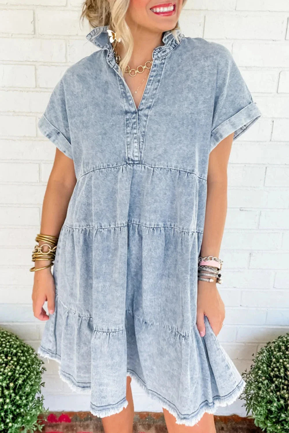 V-neck acid-wash denim dress in medium blue with a flattering silhouette for casual chic outfits.