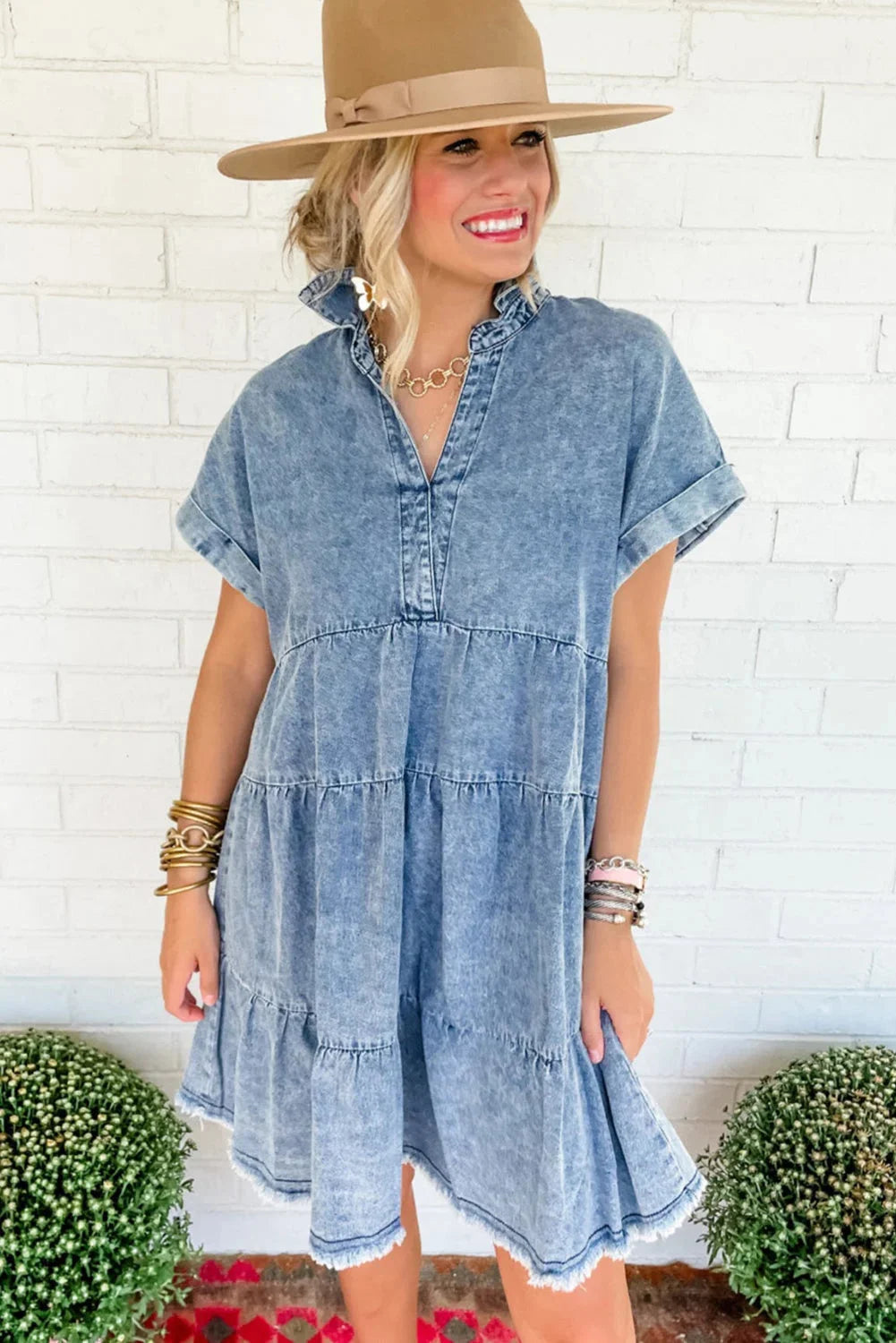 "Acid-wash denim dress with a V-neck design, a versatile and edgy addition to your wardrobe by Jane."