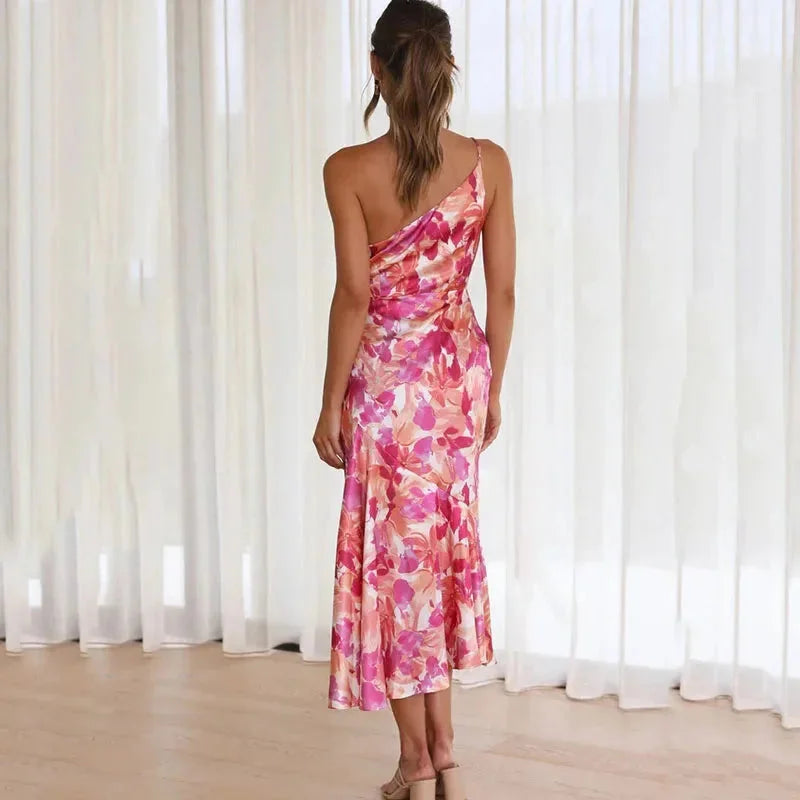 Pink floral dress with asymmetric hem, fitted silhouette, and intricate design. Crafted from high-quality fabric for a…