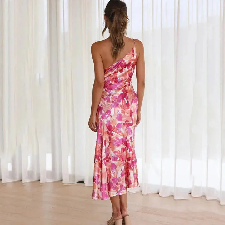 Pink floral dress with asymmetric hem, fitted silhouette, and intricate design. Crafted from high-quality fabric for a…