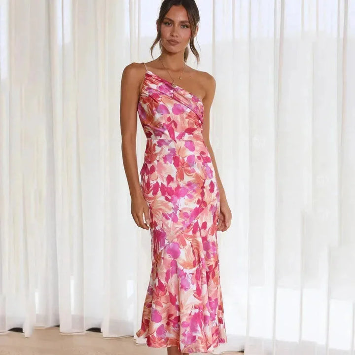 "Asymmetric pink floral dress with fitted silhouette featuring a unique design in soft and stretchy fabric."