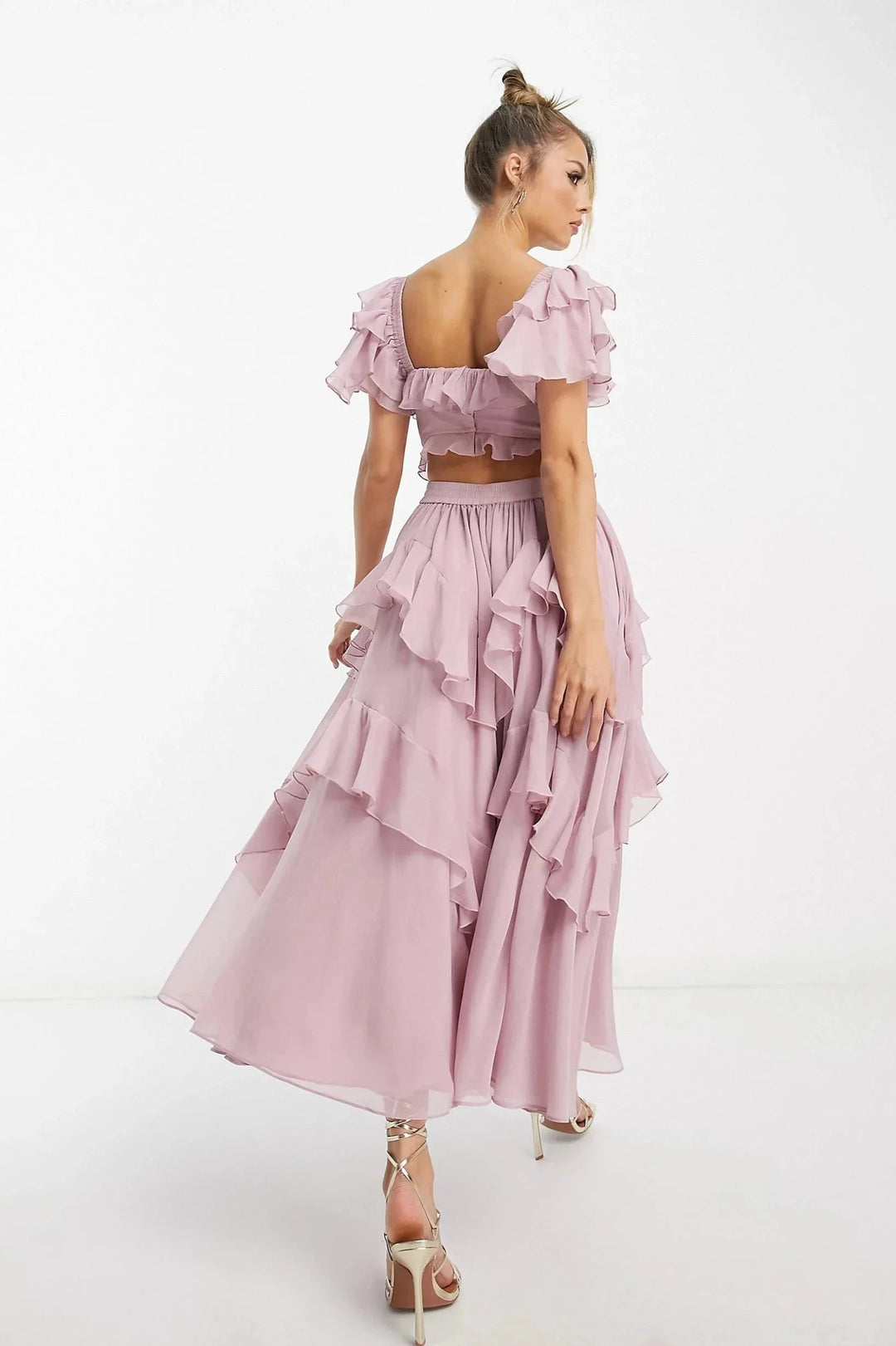 Pink ruffled puff-sleeve maxi dress showcasing a flowy silhouette with intricate design details. Made from soft and airy…