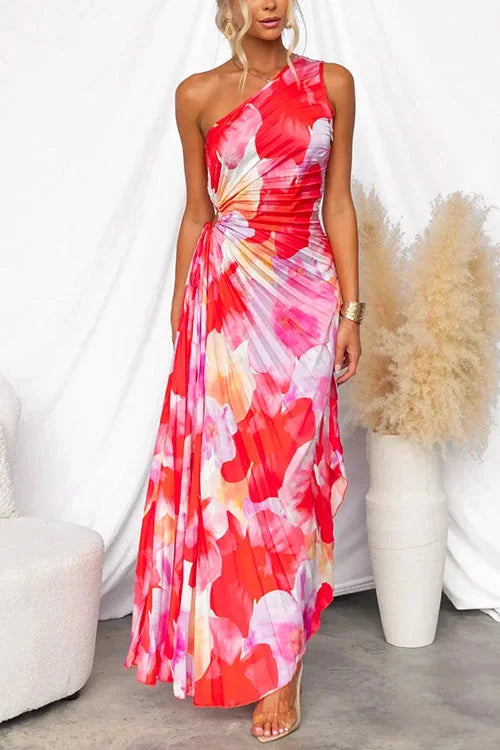 "Red floral one-shoulder dress in Rose red color. Flowy design with a playful and vibrant look, perfect for summer outings."