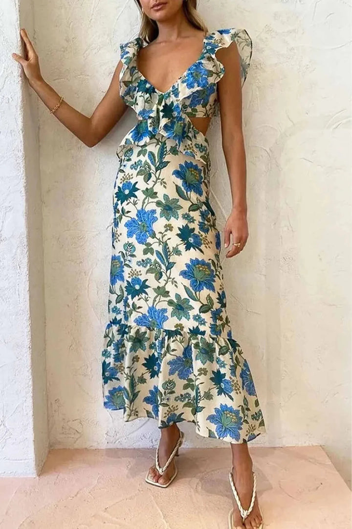 "Joan midi dress featuring a feminine floral print and V-neckline with ruffle details in a soft and flowy fabric."