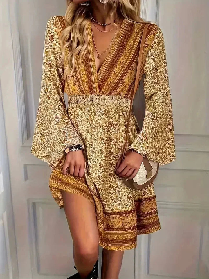 Boho-chic plus-size mini dress featuring bell sleeves and intricate pattern design for a trendy and stylish look.