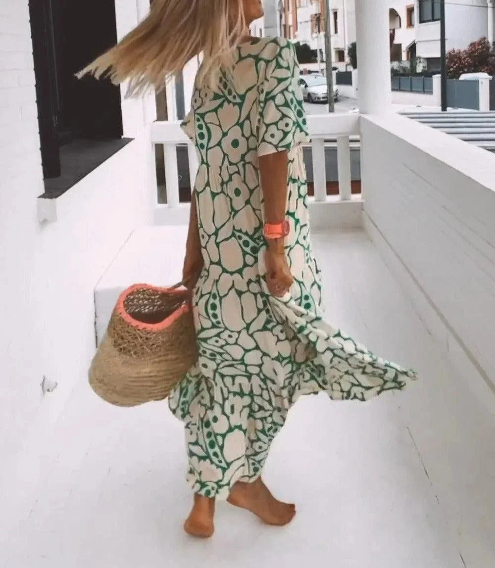 "Floral maxi dress with cap sleeves in soft, flowing fabric, perfect for casual chic occasions"