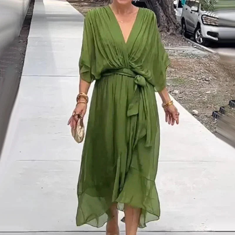 "Green v-neck midi wrap dress with tie waist, made from soft and flowy fabric, perfect for a casual yet stylish look."