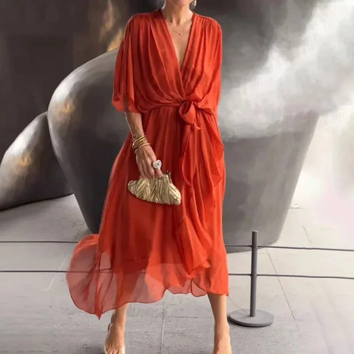 Red orange V-neck midi wrap dress with tie waist in a soft and comfortable fabric, perfect for a casual or chic look.