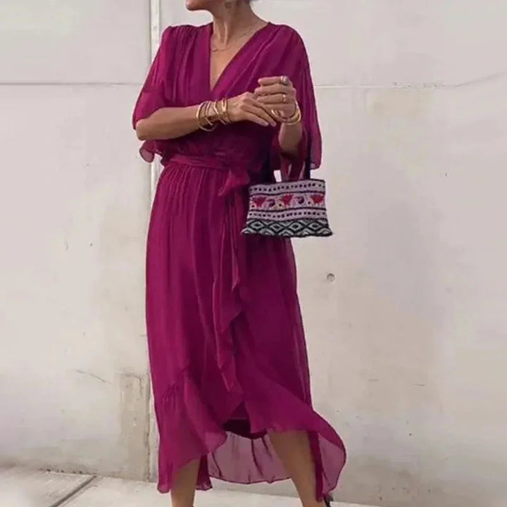 "Red violet V-neck midi wrap dress with tie waist, made of soft crepe fabric, perfect for a stylish and elegant look."