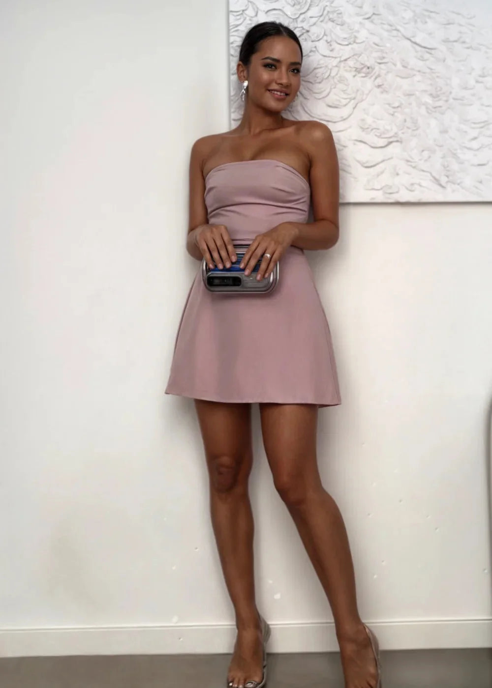 Strapless mini dress in blush with matching clutch, featuring a textured design and a chic silhouette.