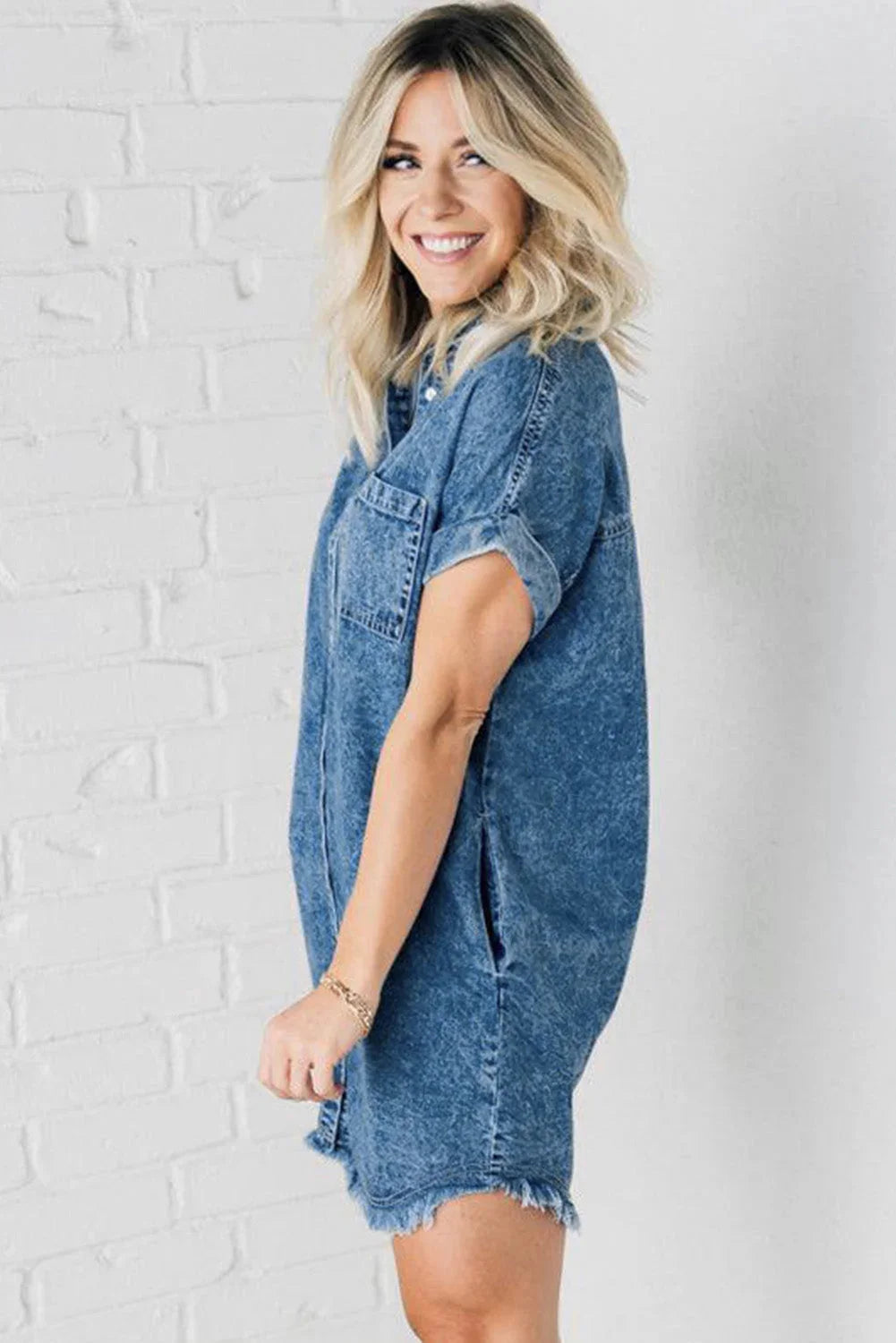 Blue denim mini dress with button-up front, perfect for a casual yet stylish look.