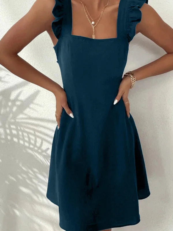 "Navy flared mini dress with ruffle detail, made of cotton blend fabric."