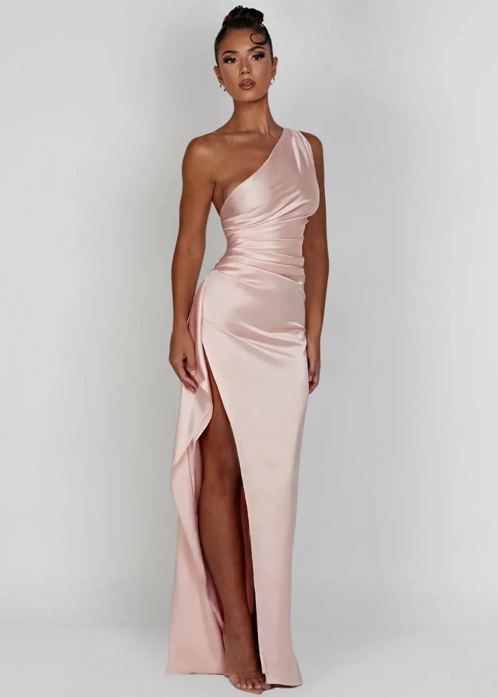 Pink Kamiya satin dress with one-shoulder design and slit detail. Silky smooth fabric for a sophisticated evening look.