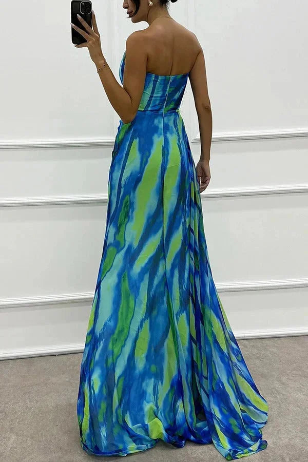 "Karla maxi dress with side slit in striking floral print, perfect for summer days. Made of lightweight, flowy fabric."