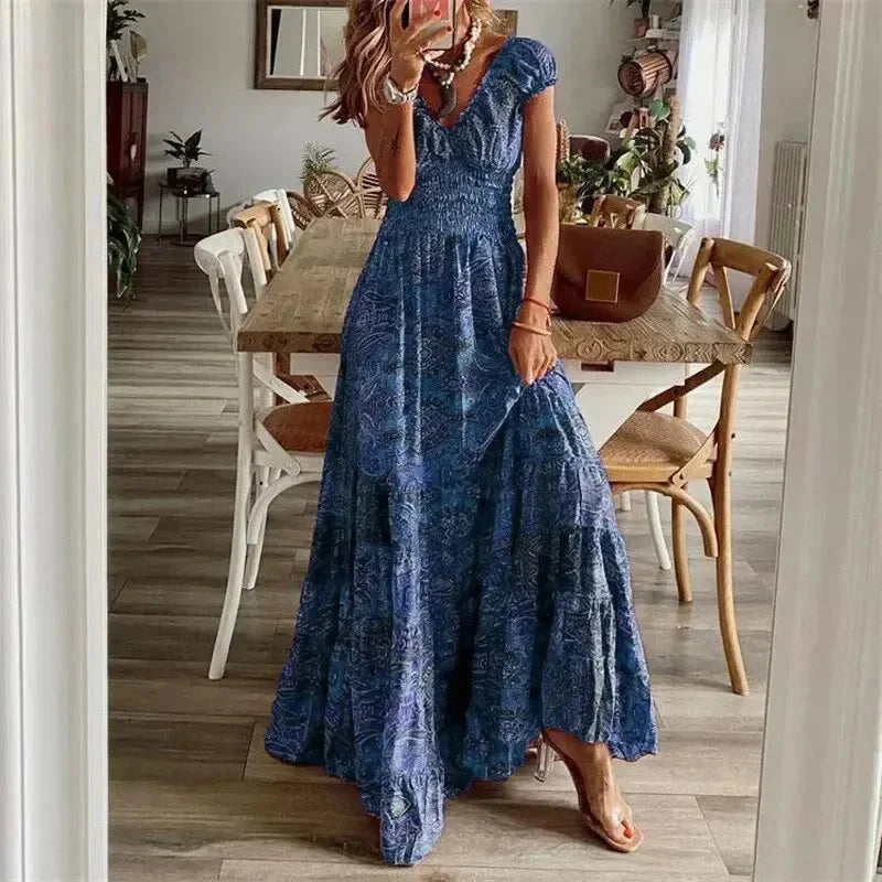 Blue tiered boho dress with sleeves, crafted from lightweight, flowing fabric for a relaxed, bohemian look.