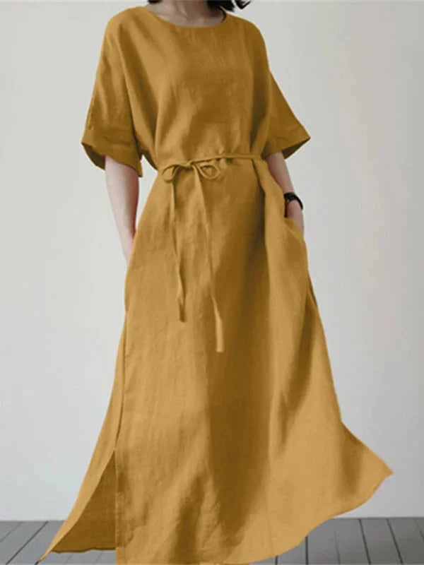 Yellow sleeveless maxi dress with adjustable tie waist. Made from lightweight flowing fabric with elegant design for a…