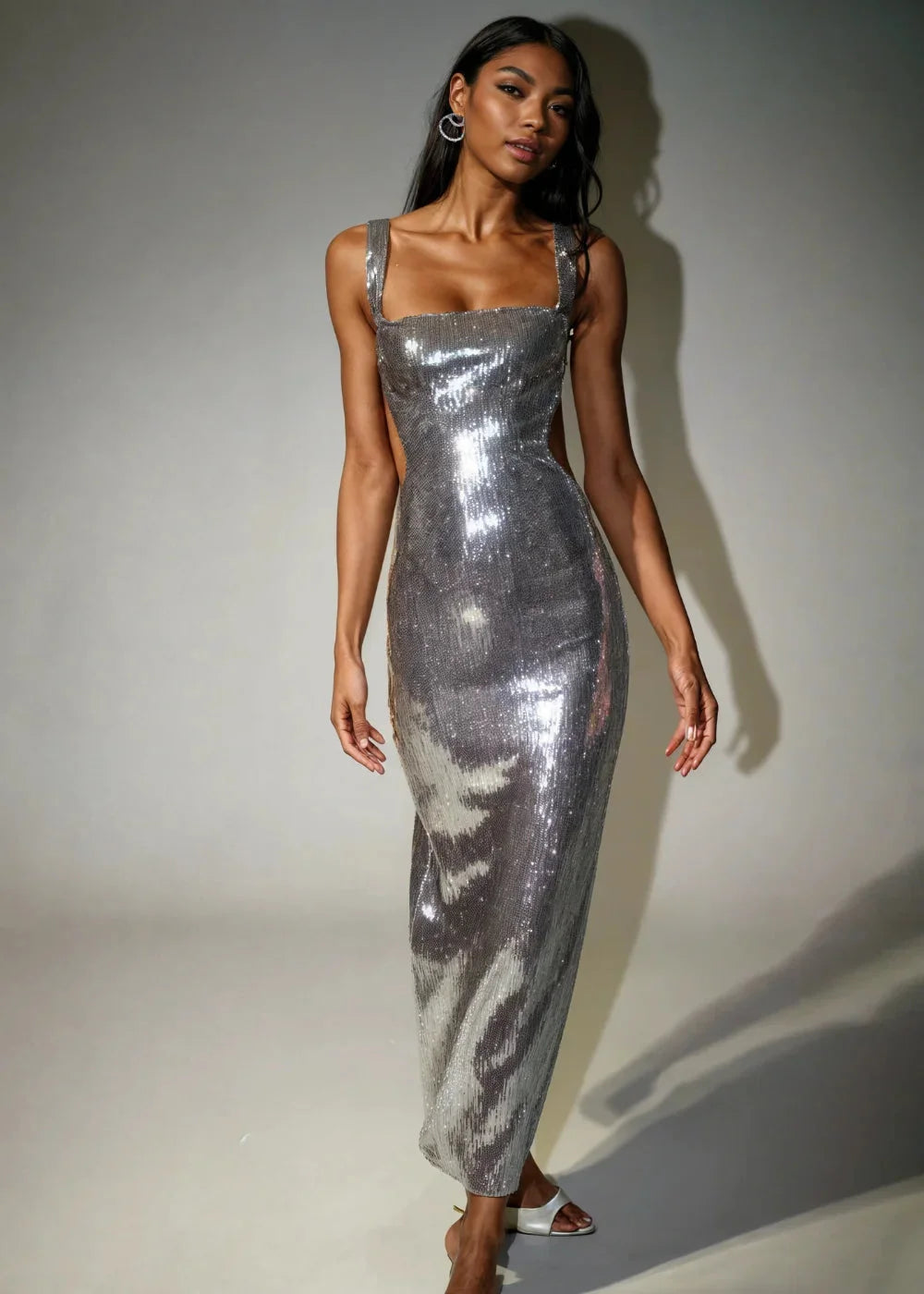 Sleeveless metallic silver sequin dress, perfect for adding glam to your outfit, features a flattering silhouette and…