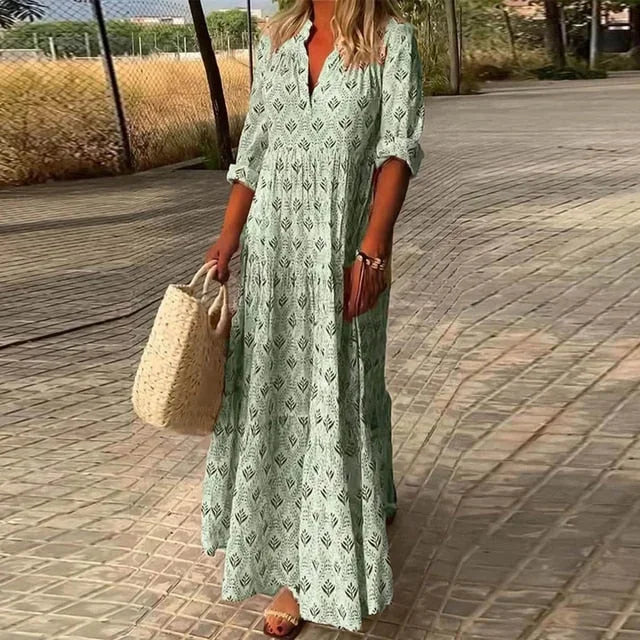 Green flowy maxi dress with v-neck made of lightweight and breathable fabric, perfect for a casual and chic summer look.