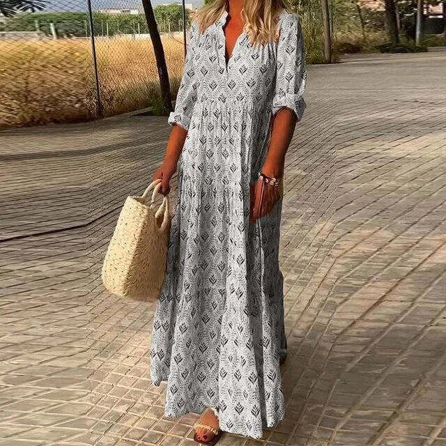 "Grey flowy maxi dress with v-neck, made of soft and lightweight fabric, perfect for a comfortable yet stylish look."