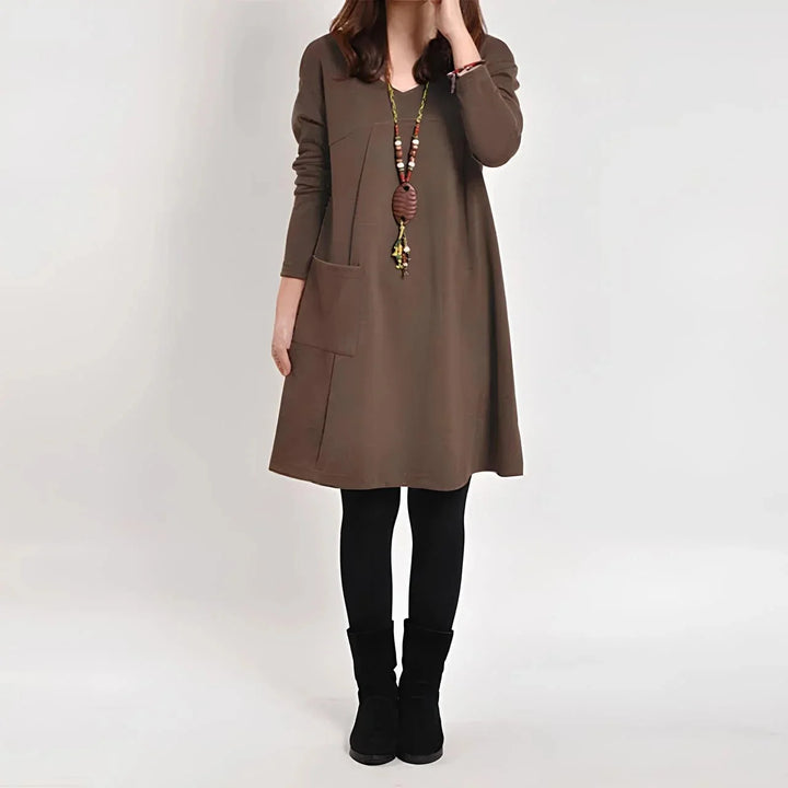 Brown long sleeve shift dress with pockets made from soft, tailored fabric, perfect for everyday wear or casual occasions.