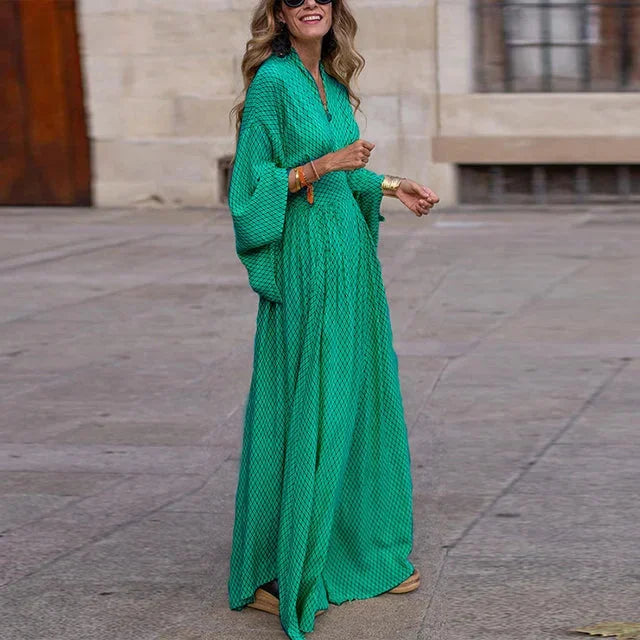 Emerald green geometric maxi dress with sleeves, featuring a modern design and made from flowing, lightweight fabric.