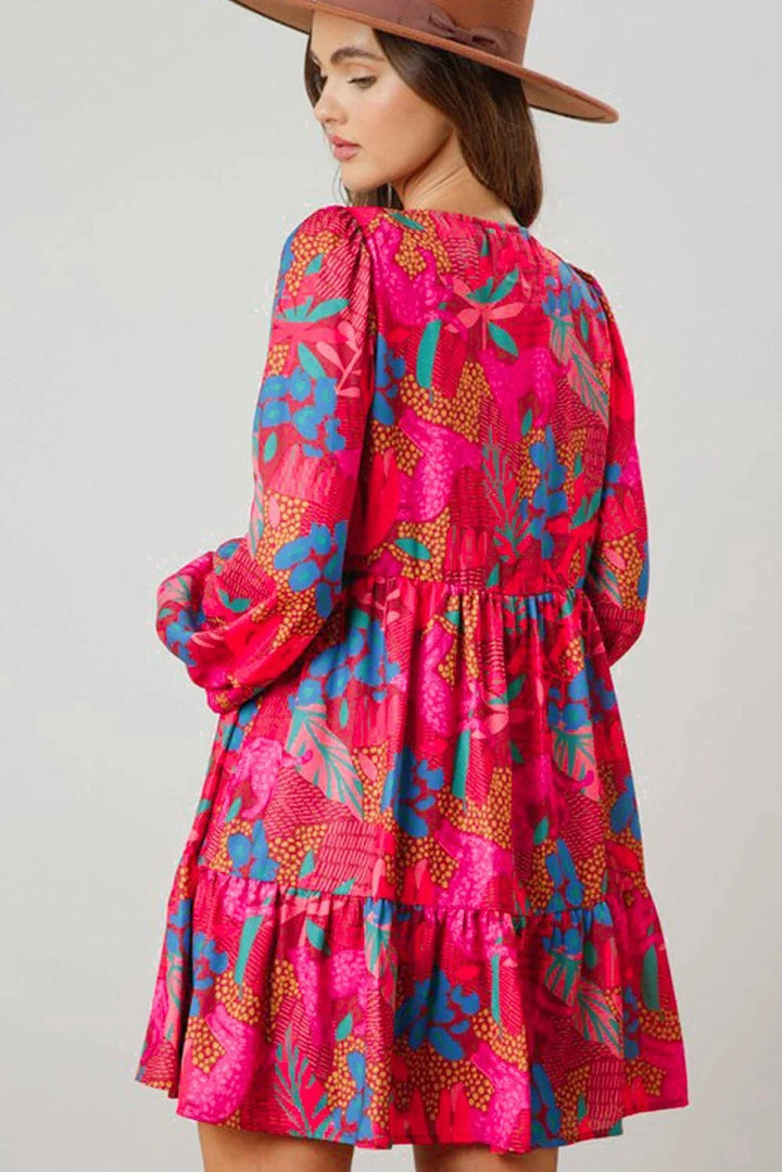 Pink bell-sleeved mini dress in flowing fabric with vibrant pattern, perfect for a chic and feminine look.