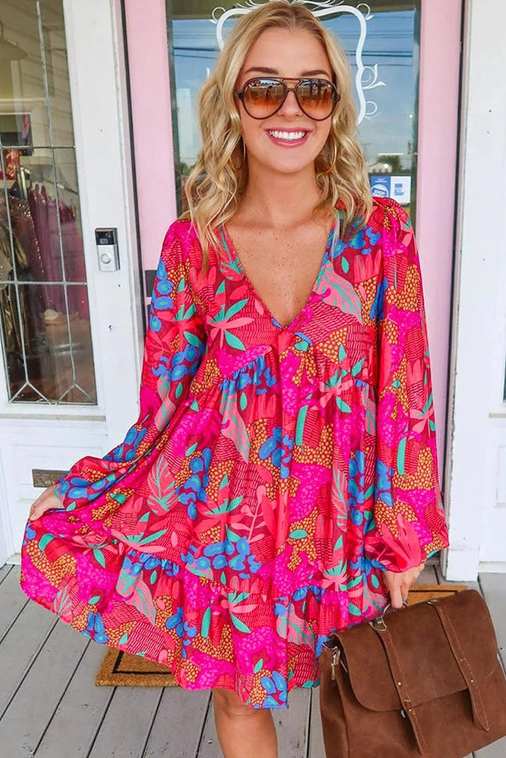 Pink bell-sleeved mini dress made of flowy cotton blend fabric with a vibrant pattern.