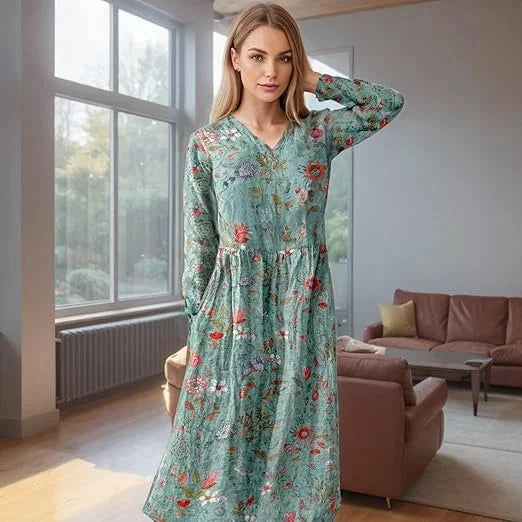 Teal floral maxi dress with long sleeves showcasing a beautiful botanical design on soft flowing fabric.