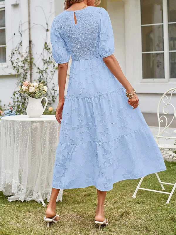 Navy blue floral textured tiered midi dress with lightweight fabric and a relaxed fit.