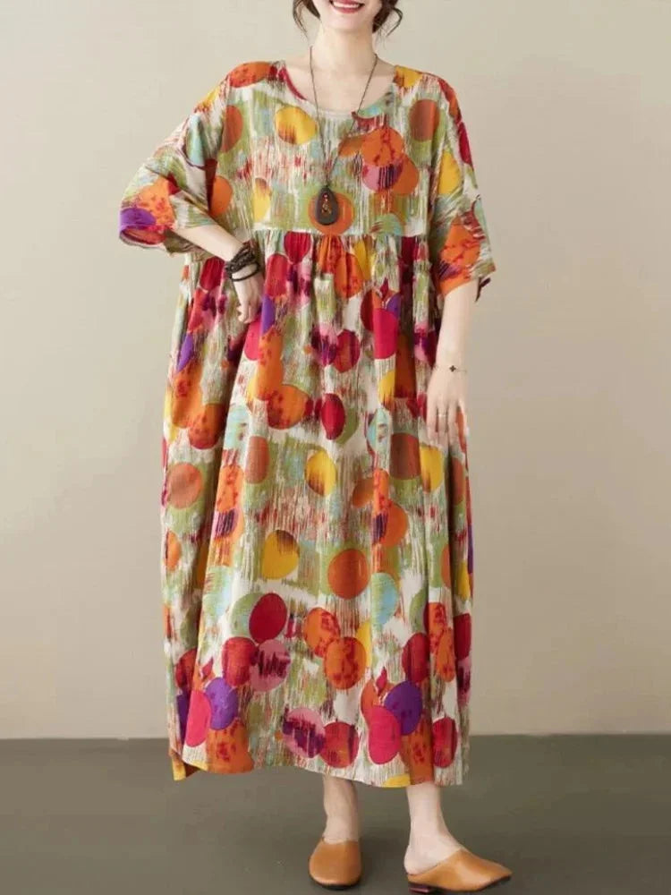 Flowy boho maxi dress with colorful artistic prints, perfect for a relaxed yet stylish look.