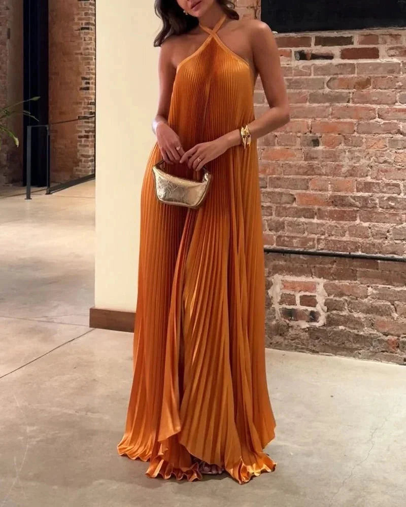 "Orange maxi dress with halter neck featuring a flowy silhouette and a vibrant color, perfect for summer outings."