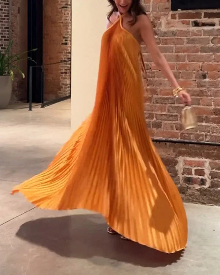 Orange maxi dress with halter neck made of flowy chiffon fabric, perfect for summer.