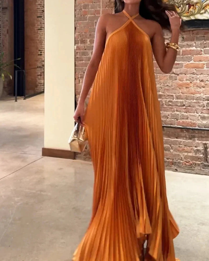 Orange maxi dress with halter neck in a flowy fabric, perfect for summer.