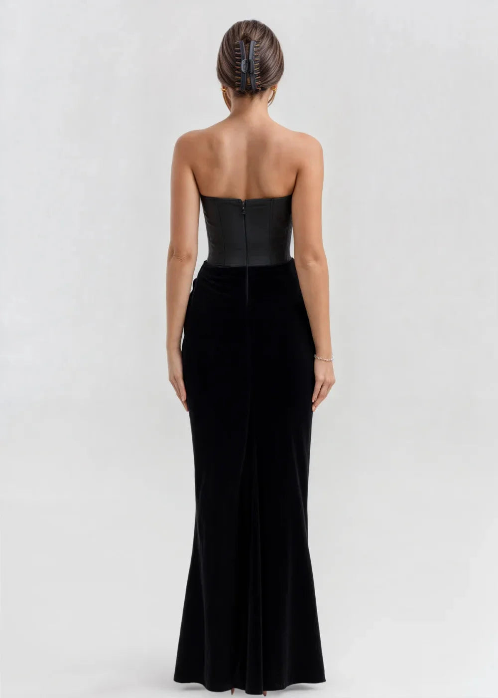 Black velvet strapless evening dress with a sleek silhouette and elegant design.