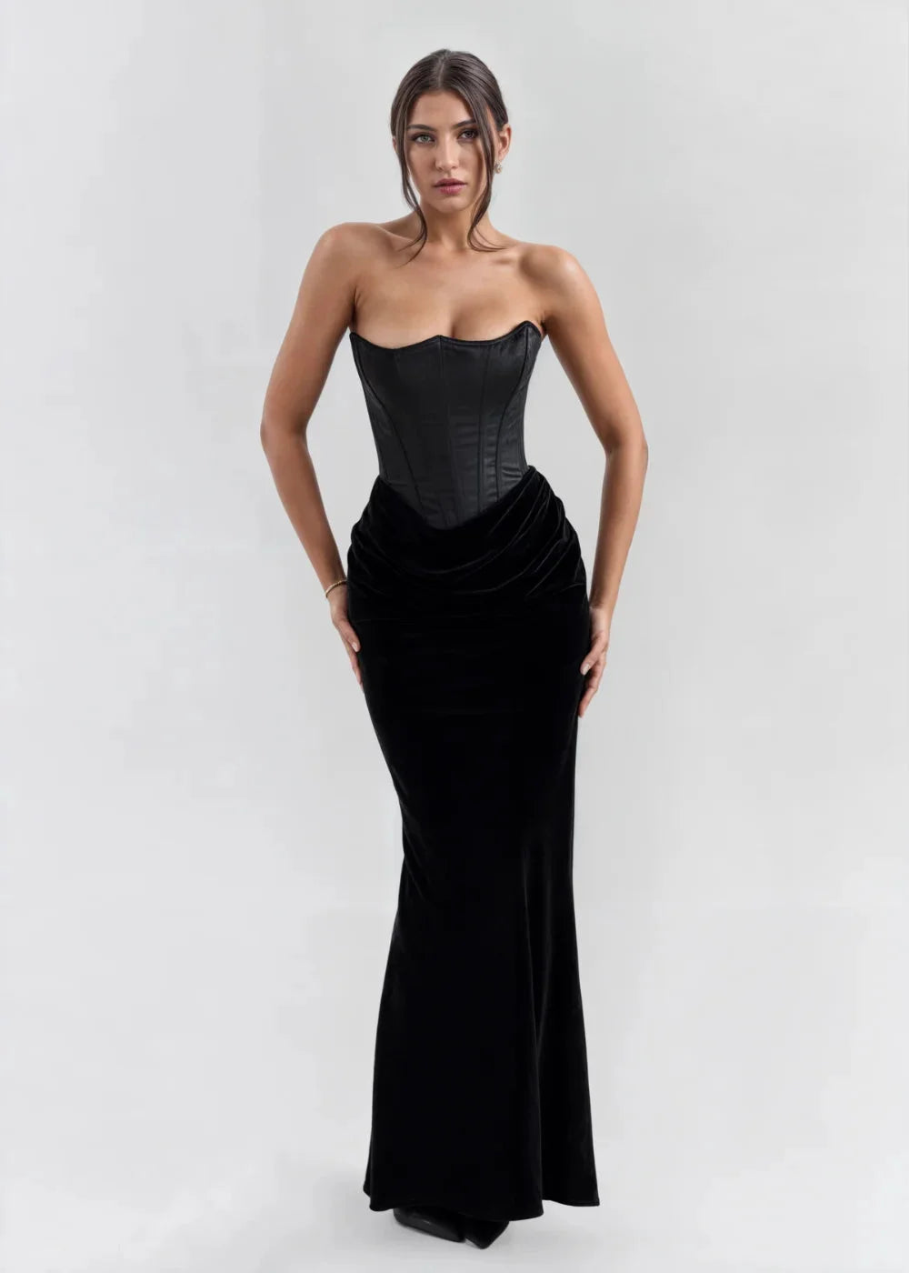 "Black velvet strapless evening dress, featuring a flattering silhouette and elegant design for a sophisticated look."