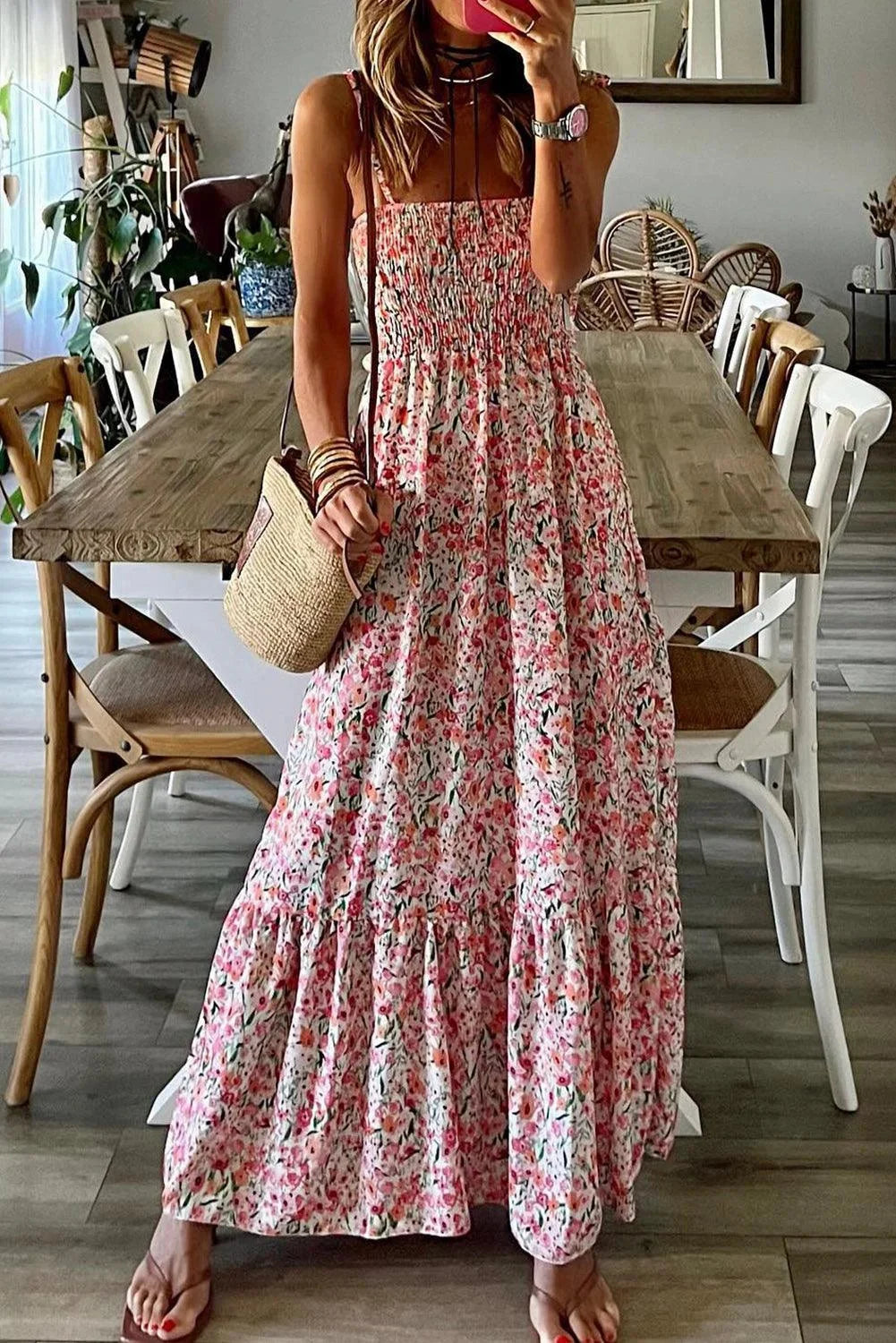 Pink smocked floral dress with tiered design in Red, showcasing a charming pattern and elegant silhouette perfect for any…